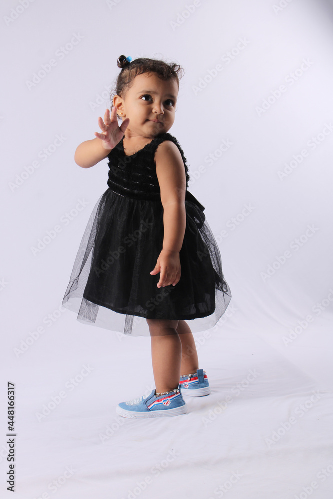 cute little adorable Indian girl saying good bye or hi whith her hand gesture. cute little adorable Indian girl saying good bye or hi whith her hand gesture.