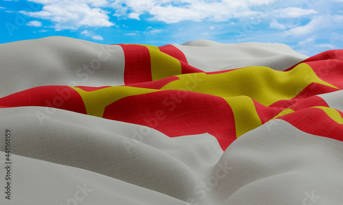 Guernsey flag in the wind. Realistic and wavy fabric flag. 3D rendering. photo