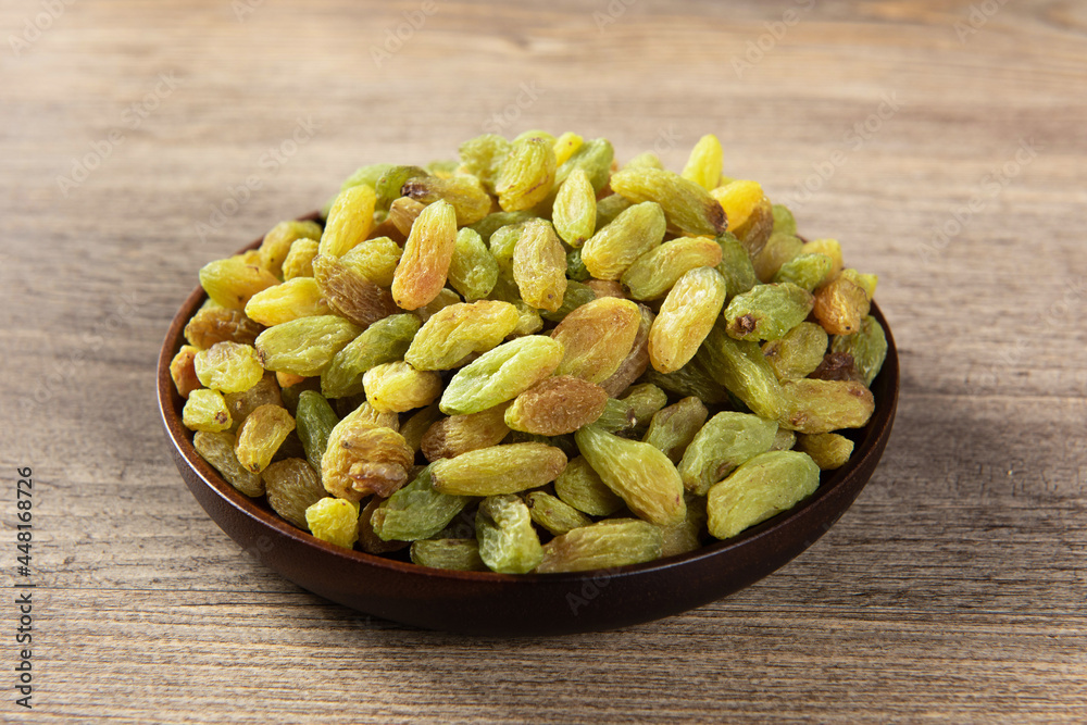 Dried fruits, green raisins on wooden table. Dried fruits, green raisins on wooden table.