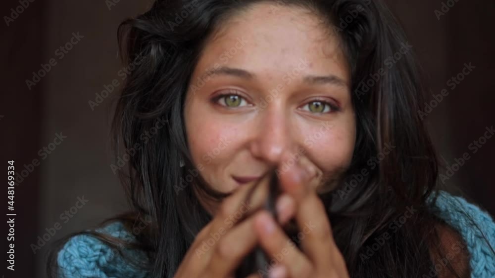 beautiful European girl long-haired brunette siting in a room on the floor, looking into the camera and smiling touches a hair with hands beautiful European girl long-haired brunette siting in a room on the floor, looking into the camera and smiling touches a hair with hands