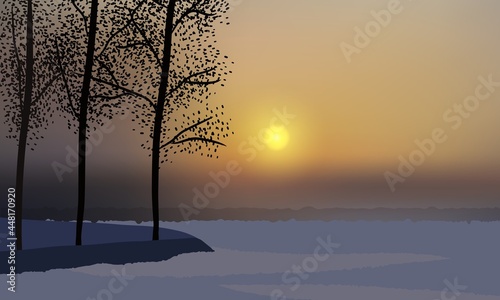 Beautiful winter sunset, camp covered with snow, trees on a hill.