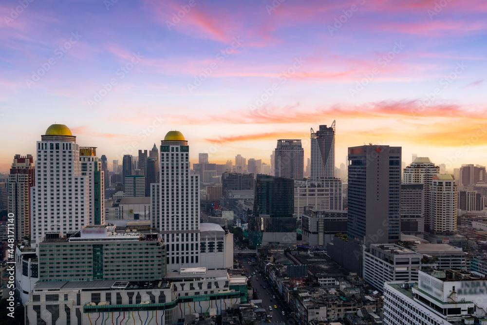Aerial view modern office buildings in Bangkok city downtown with sunset time
