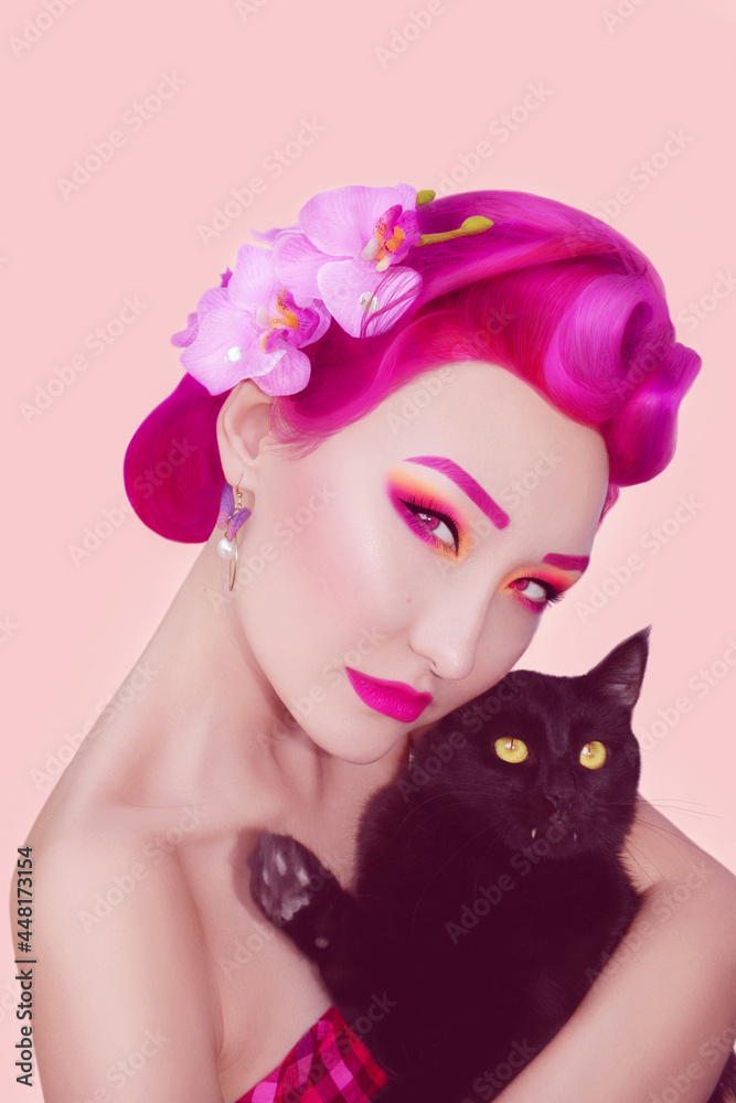 Naklejka premium Portrait of a girl with black cat in pin up style