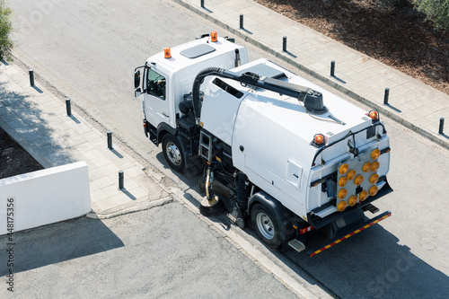 Process of cleaning street with a modern cleaning machine. Top view.