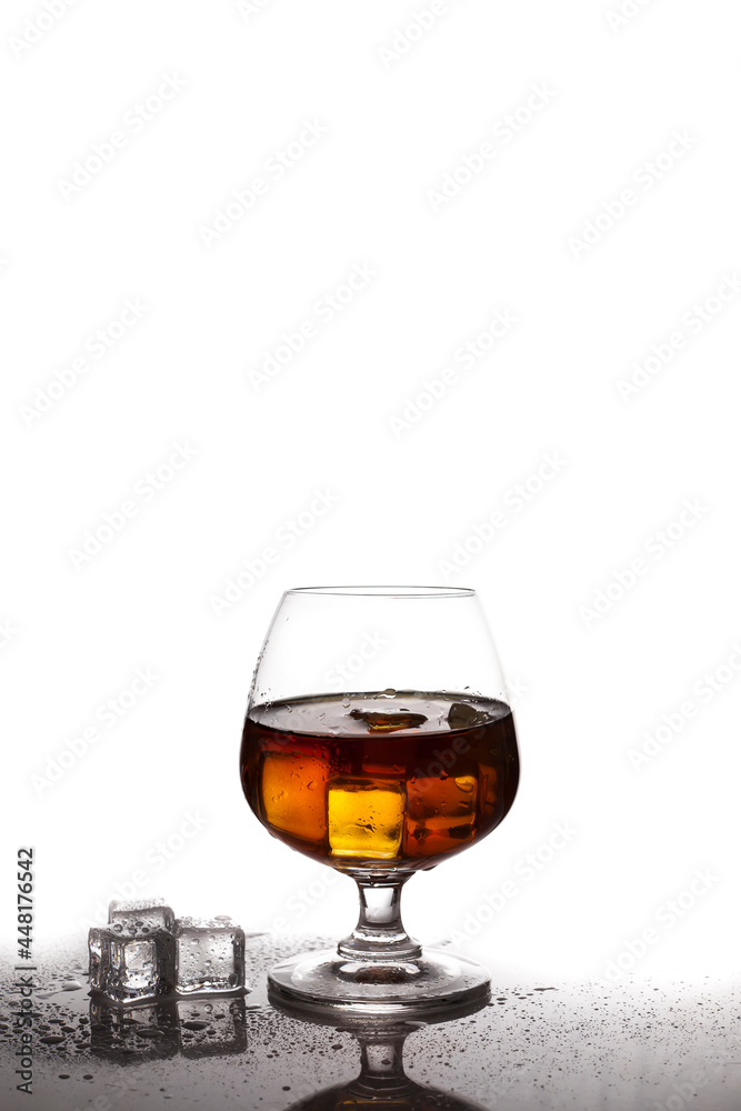 Scotch whiskey with ice in glass on table white background Scotch whiskey with ice in glass on table white background