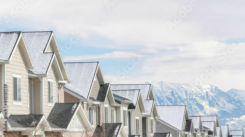 Pano Gabled townhouses with scenic mountain and overcast sky background in winter