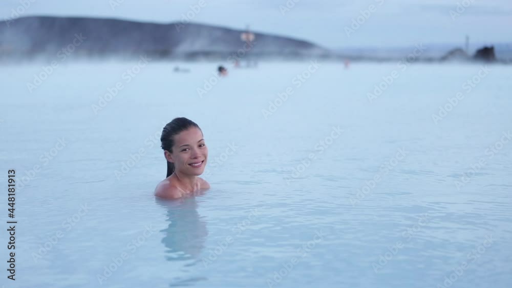 Geothermal spa. Woman relaxing in hot spring pool on Iceland. Girl enjoying bathing in a blue water lagoon Icelandic tourist attraction Geothermal spa. Woman relaxing in hot spring pool on Iceland. Girl enjoying bathing in a blue water lagoon Icelandic tourist attraction