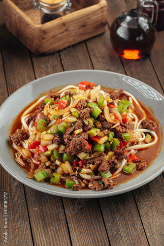 Asian uyghur dish suiru lagman noodles on a wooden background