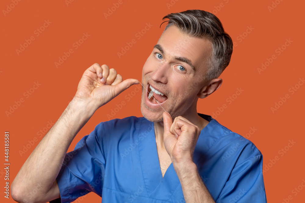 Man with open mouth and dental floss