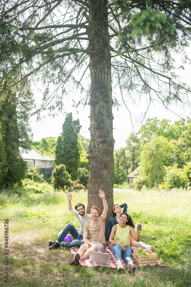 Friendly young people on picnic in park Friendly young people on picnic in park