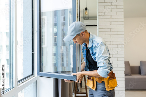 Fényképezés Construction Worker Installing New Windows In House