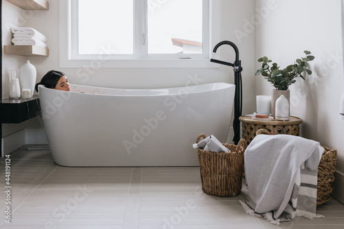 Women enjoying bath in luxury bathroom with bath photo