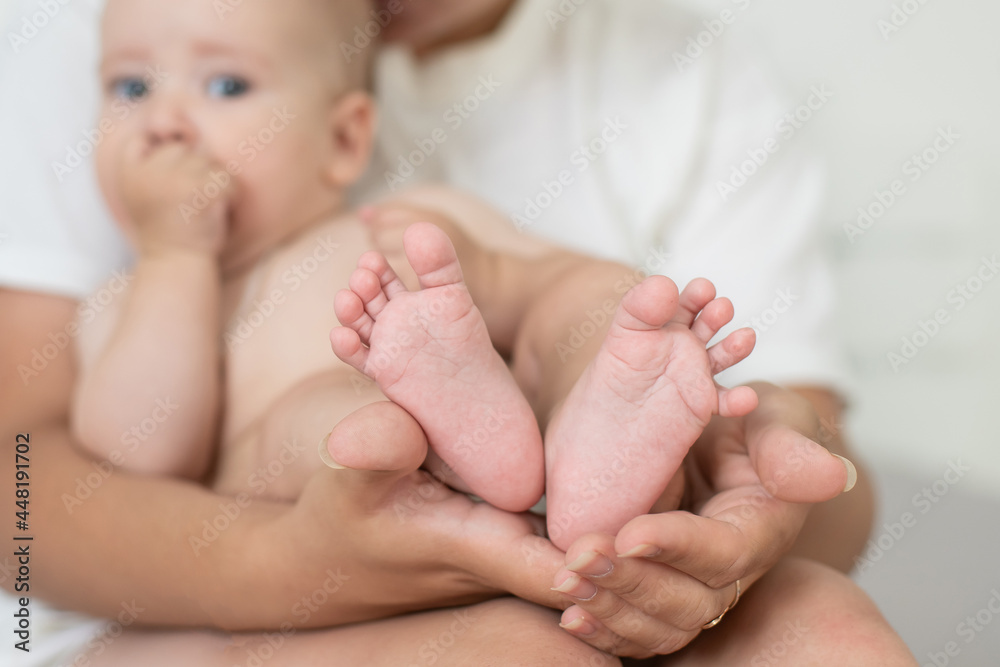 Happy smiling mother and baby lying on bed at home Happy smiling mother and baby lying on bed at home