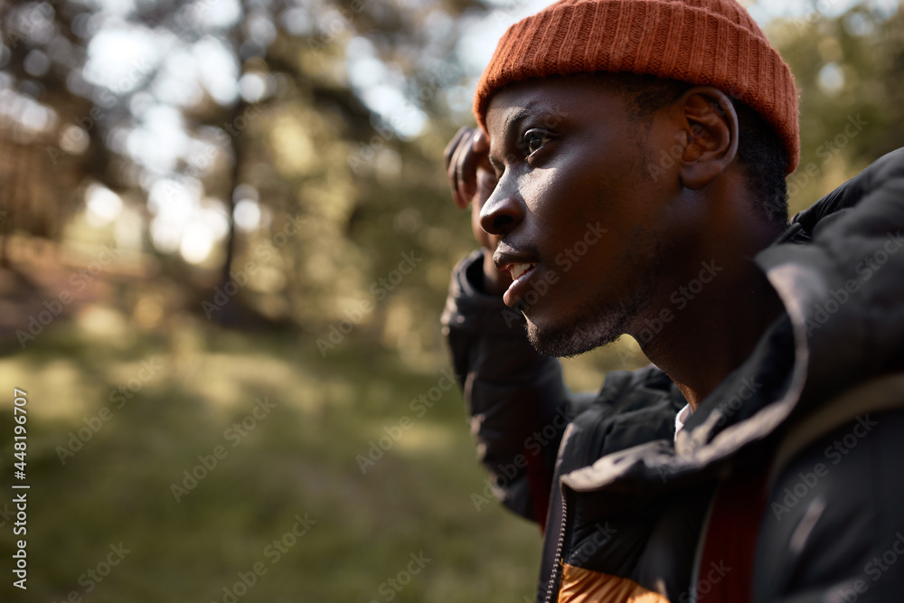 Tired afro american guy spend weekend in forest, open and fresh air for camping and hiking. Active sporty man think about route. Travelling alone, explore, adventure concept. Copy space