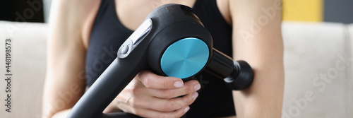 Young woman doing massage relaxing massage for hands in vibrating massager