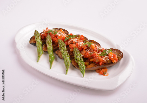 baked bbq eggplant with chef homemade salsa sauce and asparagus in white background for Christmas festival menu