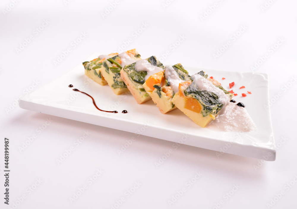 steamed egg pudding with pumpkin and vegetables with white coconut sauce in white background for Christmas festival menu steamed egg pudding with pumpkin and vegetables with white coconut sauce in white background for Christmas festival menu