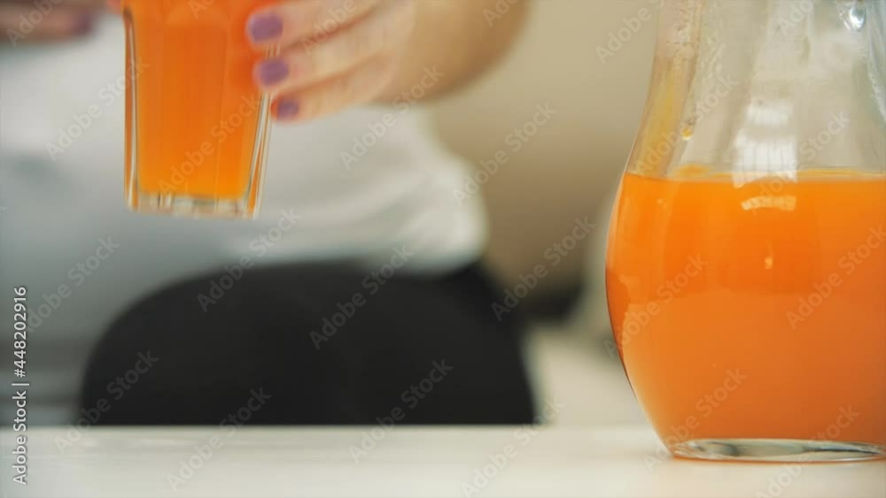 4k slowmotion video of female hand taking a glass of orange juice. 4k slowmotion video of female hand taking a glass of orange juice.