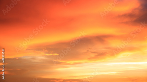 Background of orange sky and clouds with sunset light in evening at summer time when with blank copy space, showing about environment, climate concept. © Bangkok Click Studio