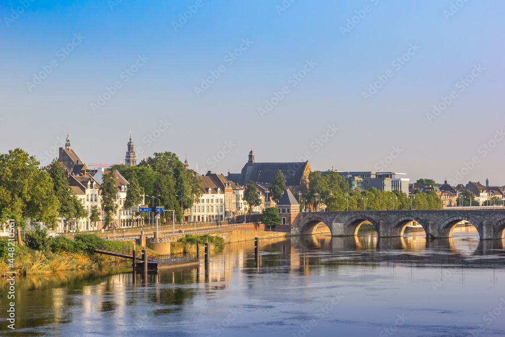 Historic Servaas bridge over river Maas at dawn in Maastricht, Netherlands