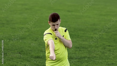 Referee goes watching VAR or violation of the rules and shows a penalty, yellow or red card . Concept of sport, rules violation, offside.