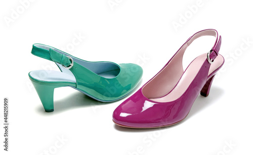 Two classic leather middle high-heeled women shoes in different colors (green and pink) isolated on white.Studio shot.