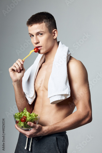 sporty man eating salad healthy food bodybuilder lifestyle