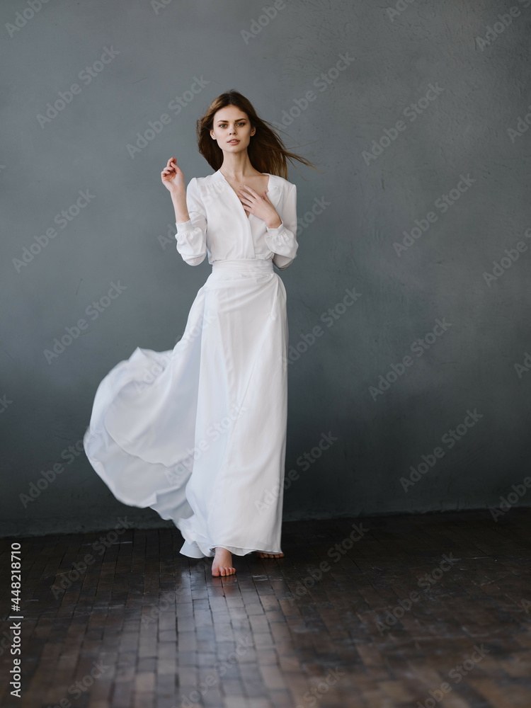 Woman in white dress posing glamor studio