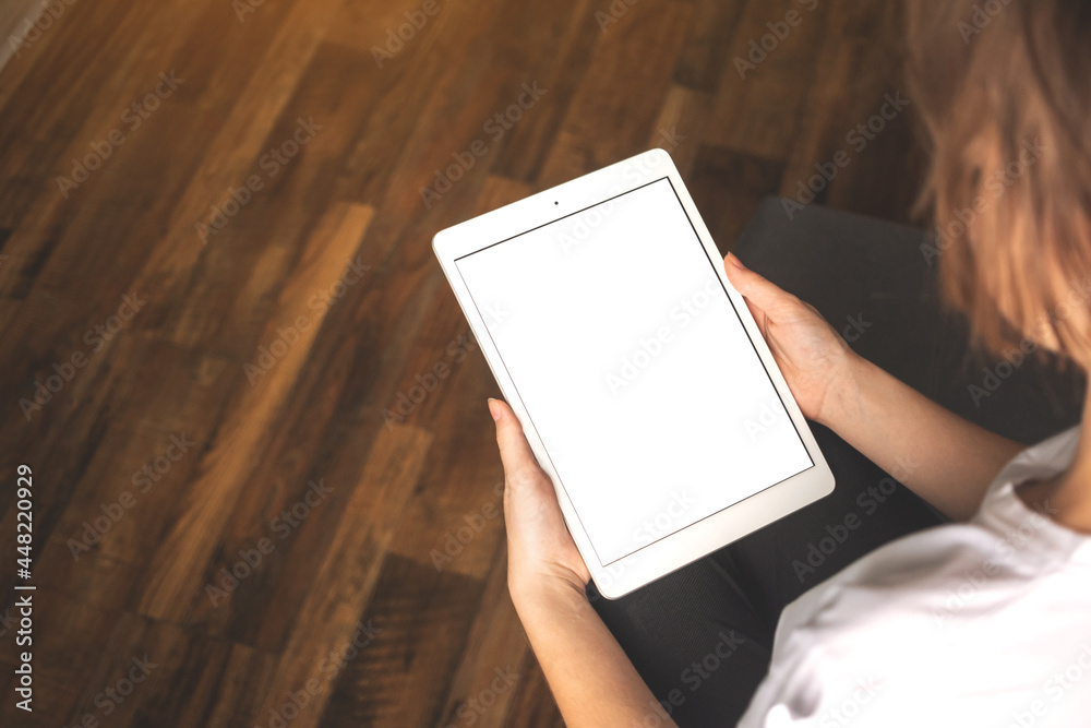 Business woman working on tablet computer. Tablet vertical screen mockup with copy space photo