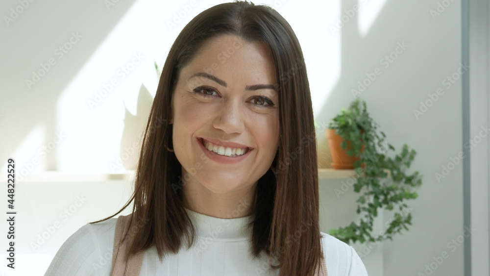 Close-up portrait of a smiling female entrepreneur looking at camera in an office or coworking. Entrepreneurial woman, business woman Close-up portrait of a smiling female entrepreneur looking at camera in an office or coworking. Entrepreneurial woman, business woman