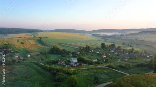 Sunrise in village with fog