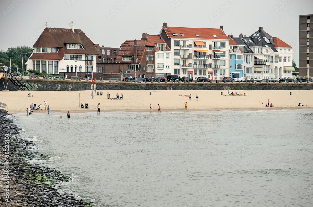 Vlissingen, The Netherlands, July 24, 2021: part of the city's sea front, with a sandy beach and the promenade Vlissingen, The Netherlands, July 24, 2021: part of the city's sea front, with a sandy beach and the promenade