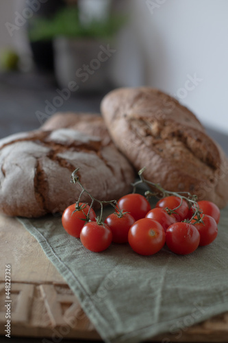 Freshly baked bread with tomatoes on the table