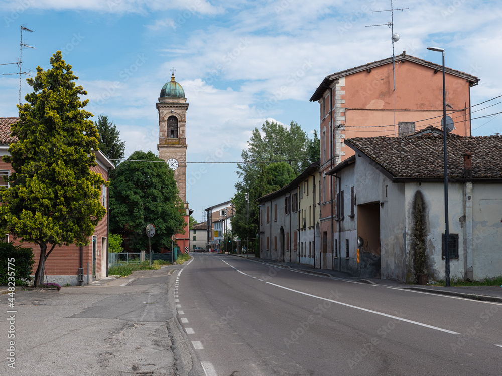 View of the via Emilia Road with Bell Tower of the Church of San Giacomo Apostolo in Cadè in the province of Reggio nell'Emilia, Italy