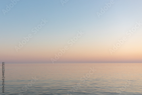 sunset sun by the ocean, clear water and sandy azure beach © Ванжа Юрий