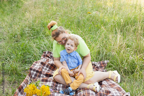 A mother gently hugs a disabled child. Infantile cerebral palsy. Enabling. Disability. A family with a disabled child.