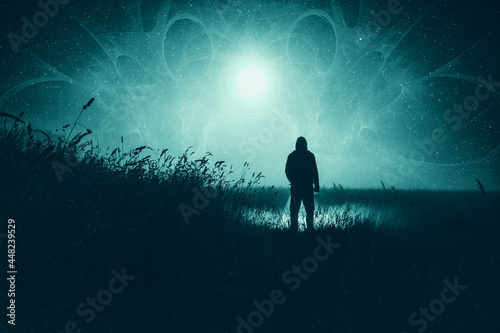 A moody science fiction concept, of a figure standing in a field with UFO lights glowing in the sky. On a foggy spooky night.
