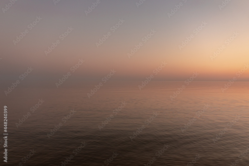 sunset sun by the ocean, clear water and sandy azure beach