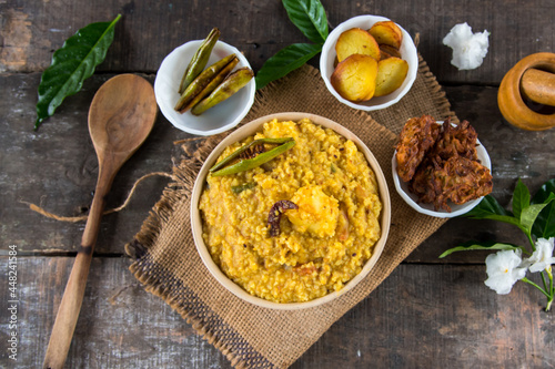 Dal khichadi or khichdi a delicious Indian recipe made of yellow dal or lentils and rice . Selective focus. It is generally accompanied with fried vegetables. photo