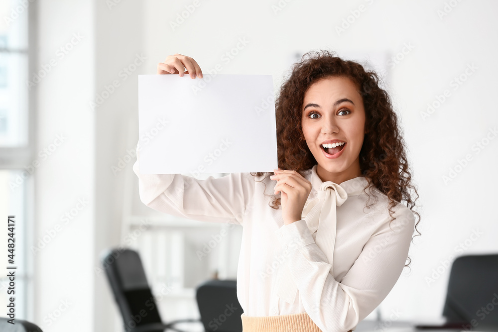 Young woman with blank paper sheet in office Young woman with blank paper sheet in office