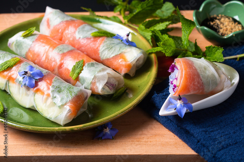 Healthy food concept Fresh smoked salmon rice paper spring rolls with colorful vegetable with copy space