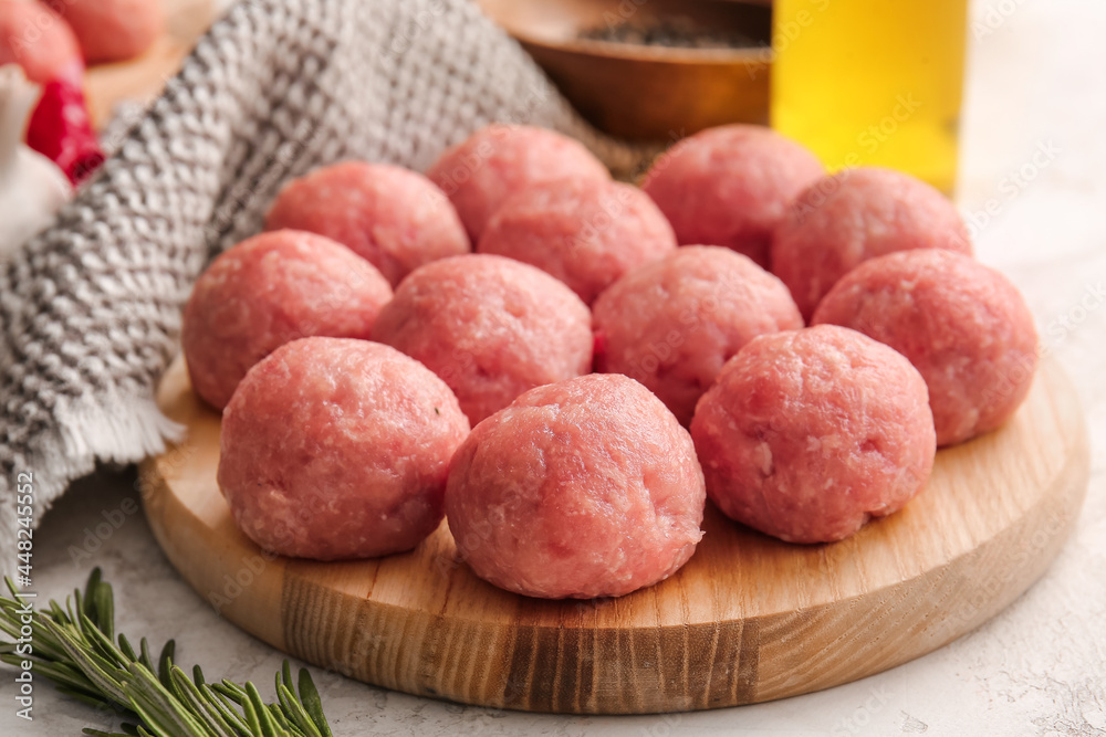 Wooden board with raw cutlets made of fresh forcemeat on table, closeup Wooden board with raw cutlets made of fresh forcemeat on table, closeup