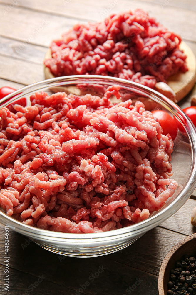 Bowl with fresh forcemeat on wooden background Bowl with fresh forcemeat on wooden background