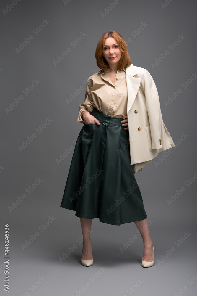 full length portrait of a fashionable aged woman isolated on grey full length portrait of a fashionable aged woman isolated on grey