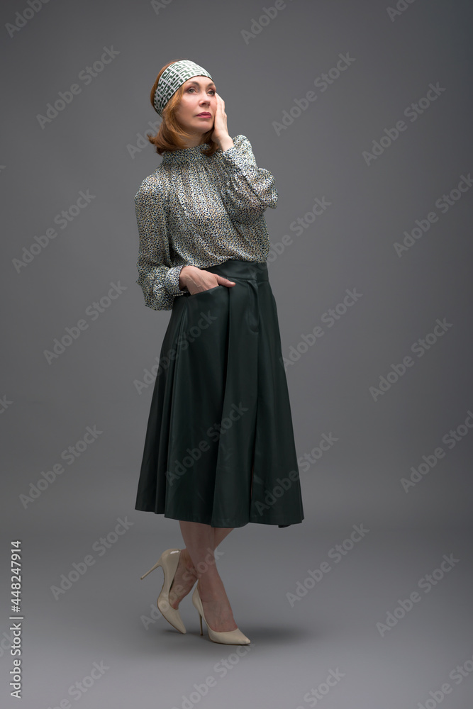 full length portrait of a fashionable aged woman isolated on grey full length portrait of a fashionable aged woman isolated on grey