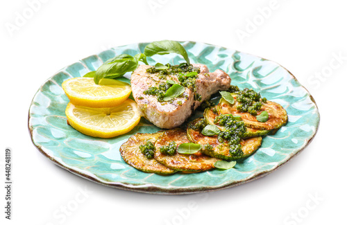 Plate with grilled zucchini, steak and pesto sauce on white background