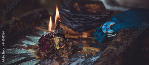 Candle burns on the altar, magic among candles, clean negative energy, wicca concept photo