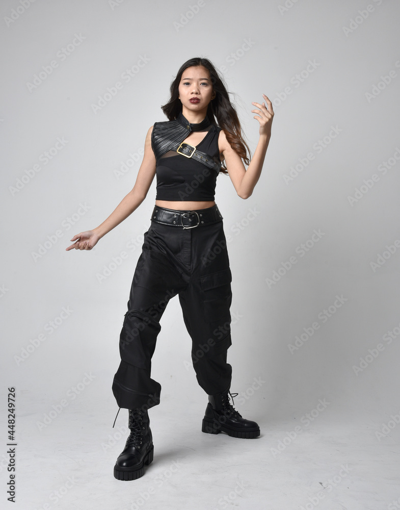 Full length portrait of pretty young asian girl wearing black tank top ...
