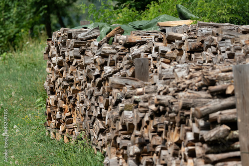 Firewood stacked for outdoor drying. Drying wood for the fireplace. photo