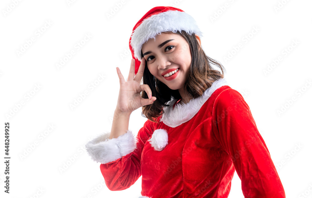 Smiling of young Asian woman wearing santa costume showing ok sign isolated over white background. Smiling of young Asian woman wearing santa costume showing ok sign isolated over white background.